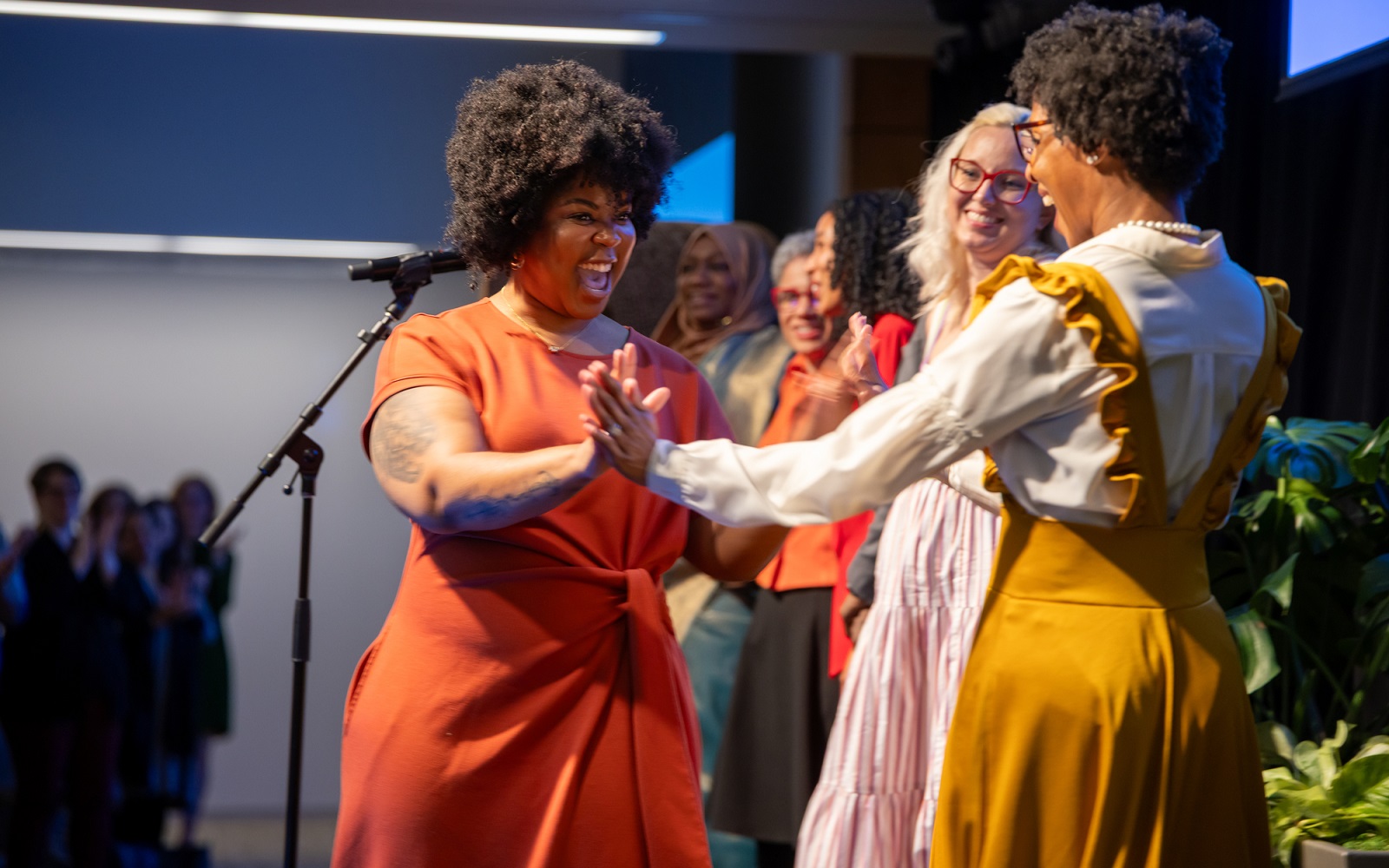 Speakers celebrate at a storytelling event