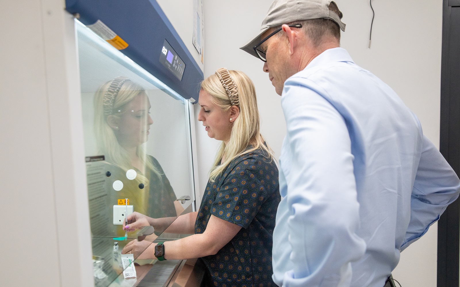 Elzaan (L), a pharmacist at the M72 BePart Yoluntu Clinical Trial Site, demonstrates to Founder and Executive Director Ingrid Hansen how a TB vaccine is prepared in Western Cape, South Africa.