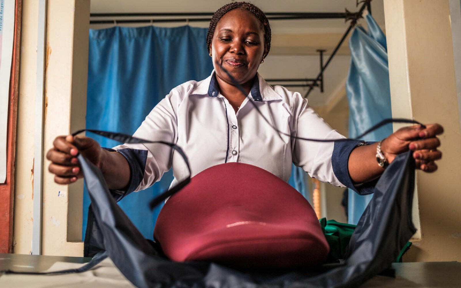 A nurse manager demonstrates a blood-loss drape used to prevent postpartum hemorrhage