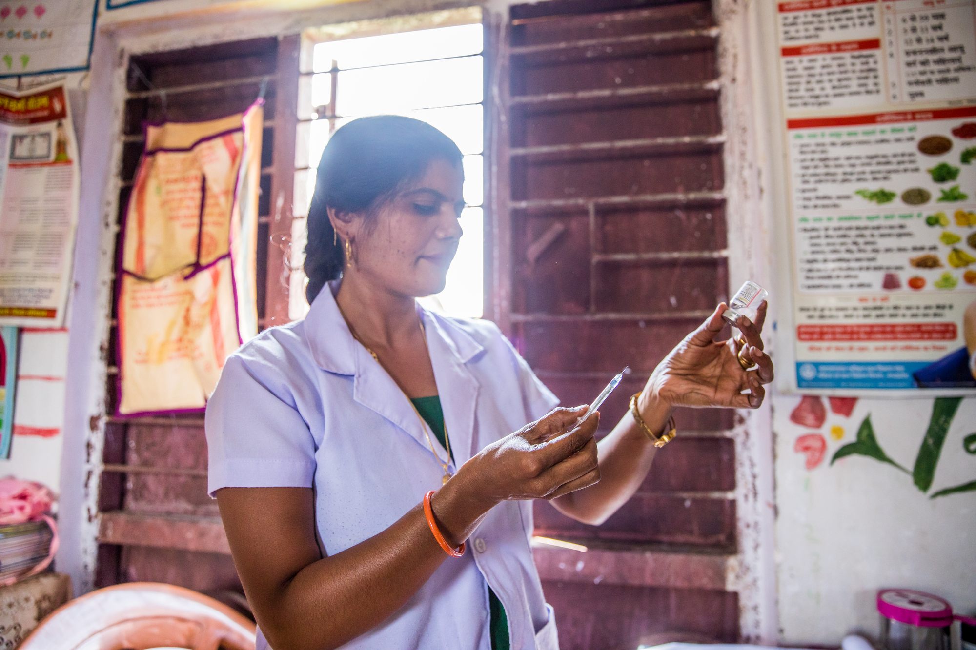 Gayatri Ahirwar, a nurse midwife, prepares a vaccination in a health center where she supports mothers and newborns in Madhya Pradesh, India.