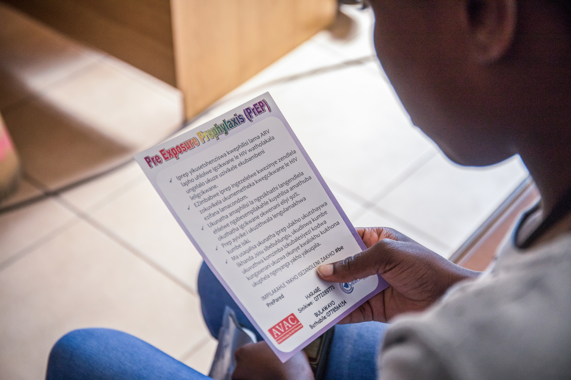 A client reading an HIV prevention flyer