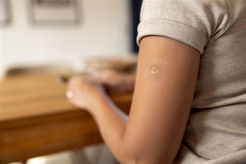 A microarray vaccine patch on a person’s arm