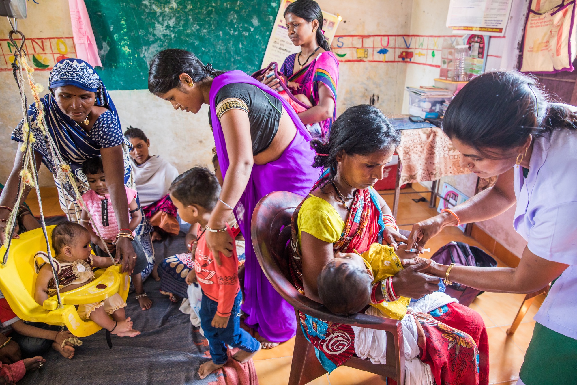 A health worker examining a child