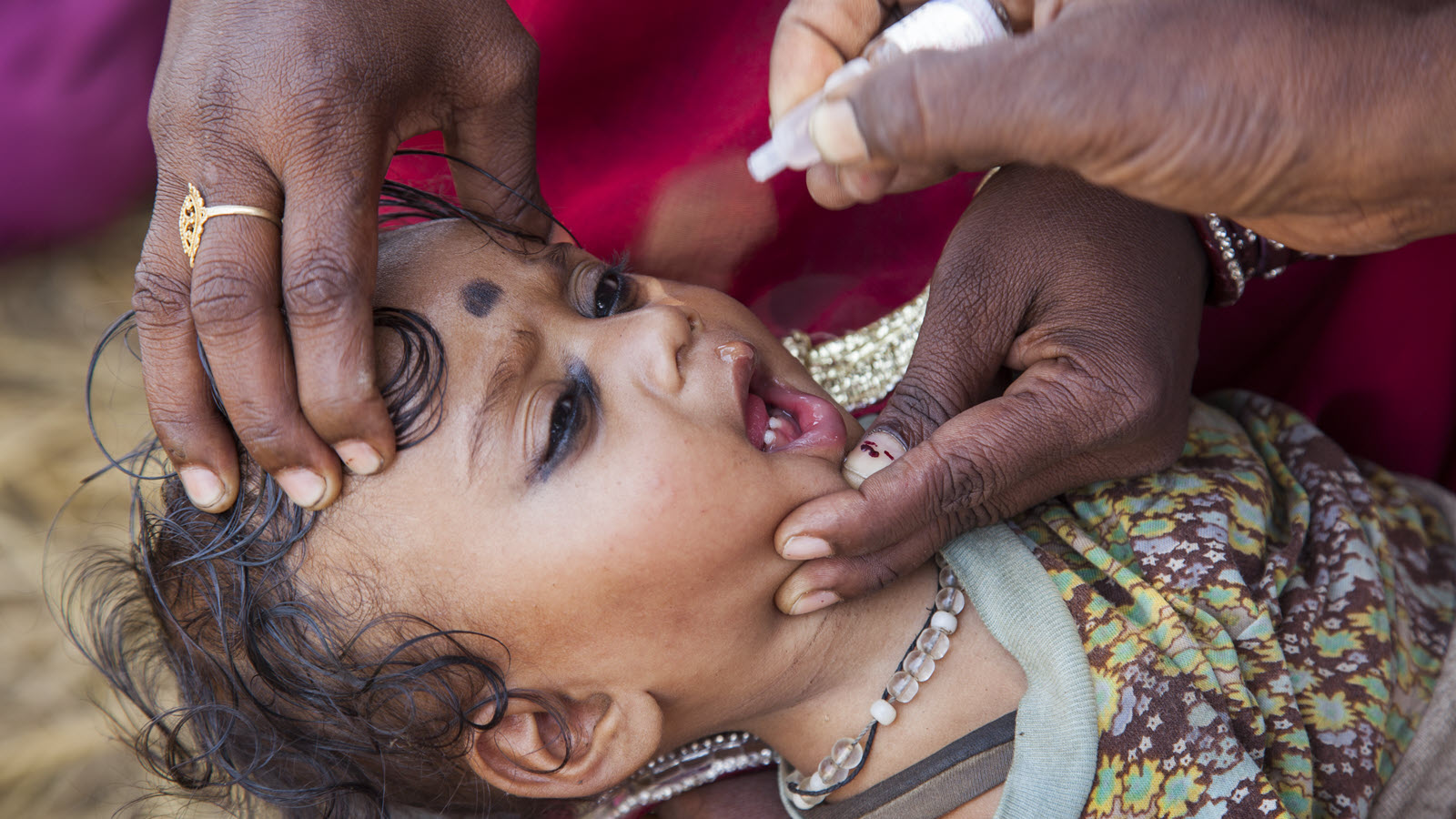A community health worker visits a family with a young child in Bihar.