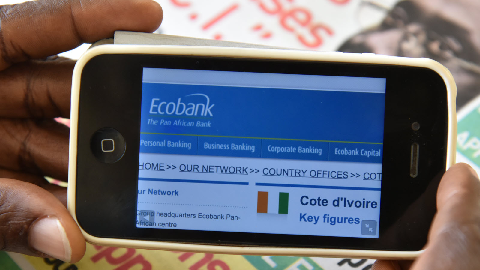 A person uses a smartphone for a digital financial services transaction in Kenya.