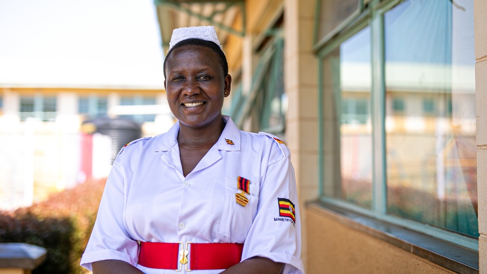 A nurse in a white uniform smiling