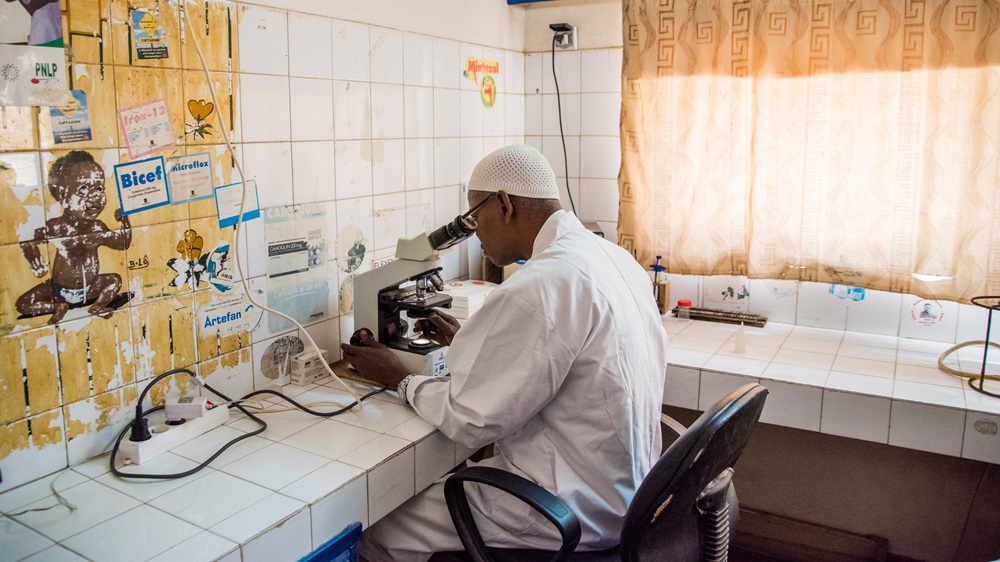 A researcher using a microscope in a laboratory