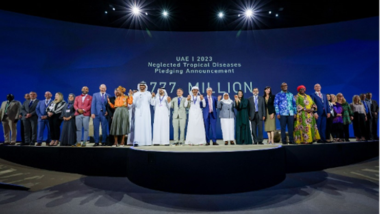 Partners on stage at a pledging announcement