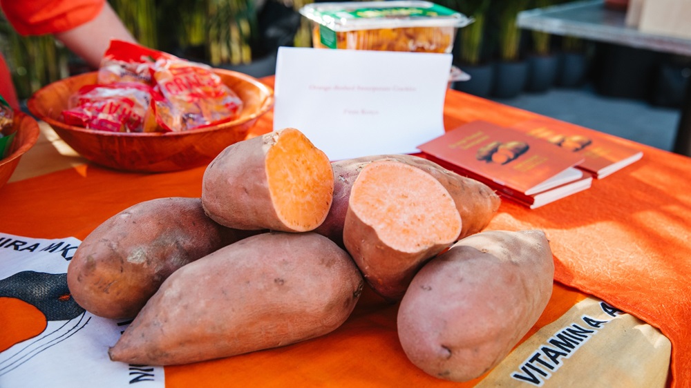 Orange sweet potatoes in a wooden bowl