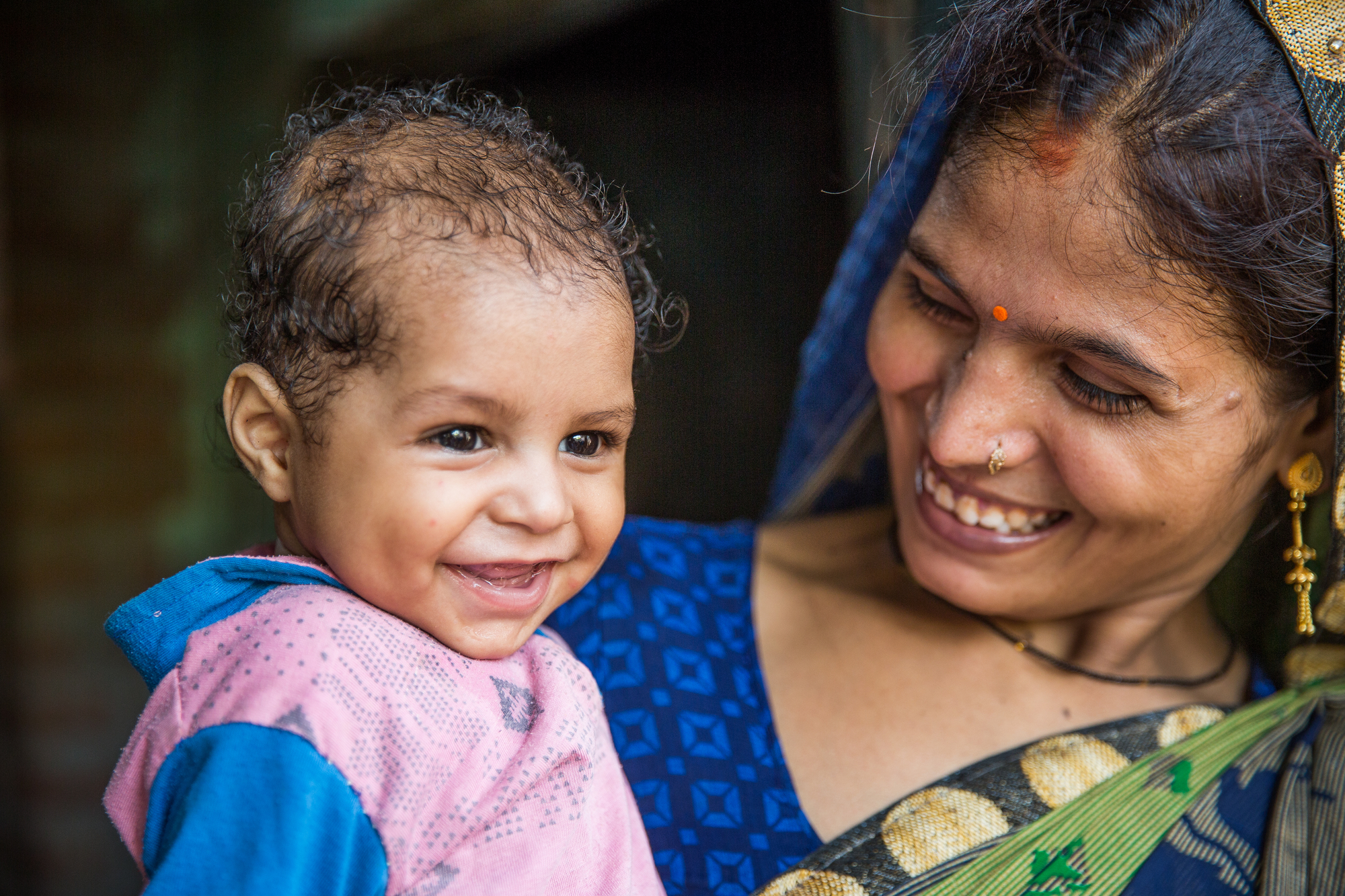Jyoti shares a moment with her son Harsh in their home in Banthar village, Unnao District, Uttar Pradesh, India.