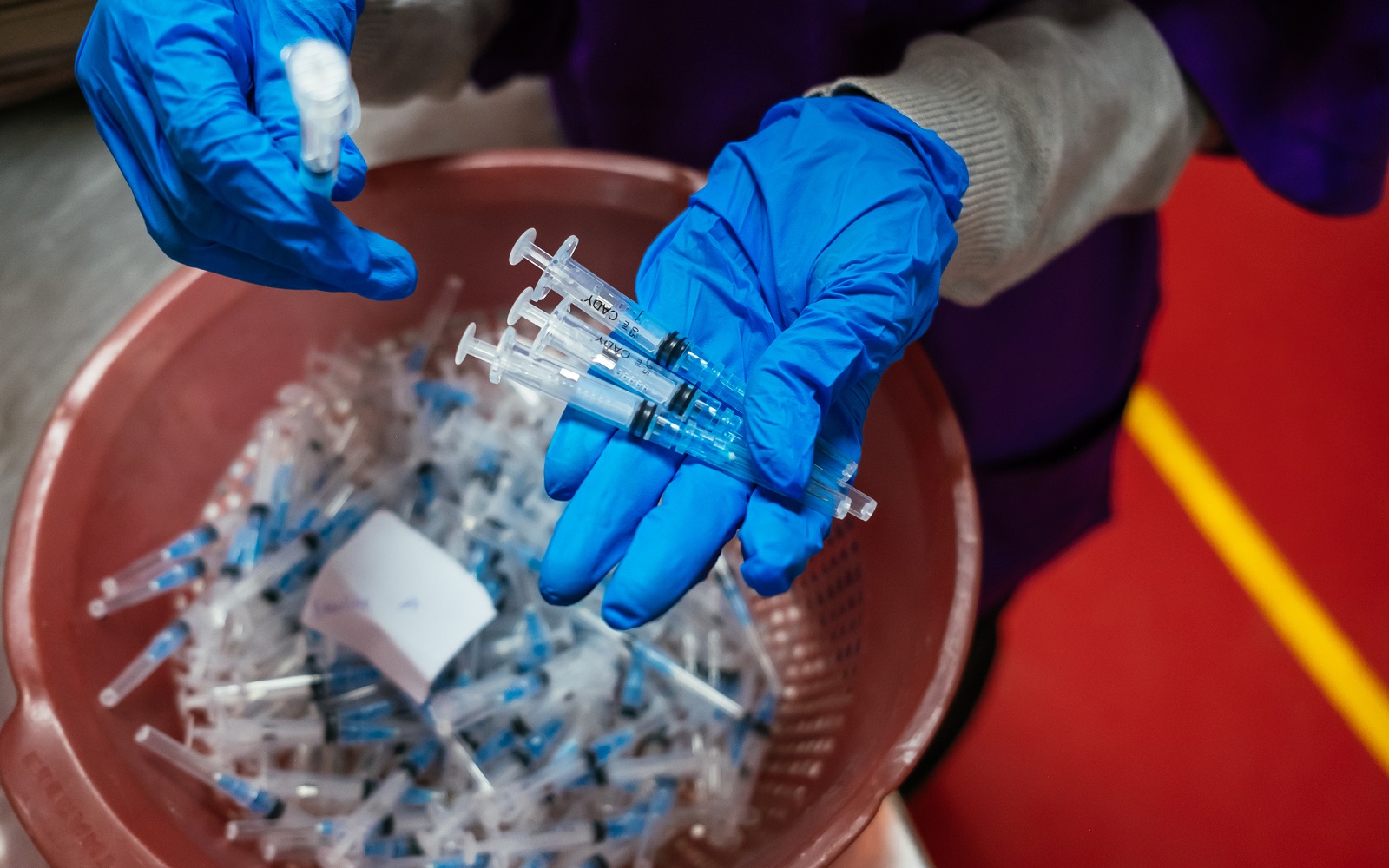 Hands holding auto-disable syringes